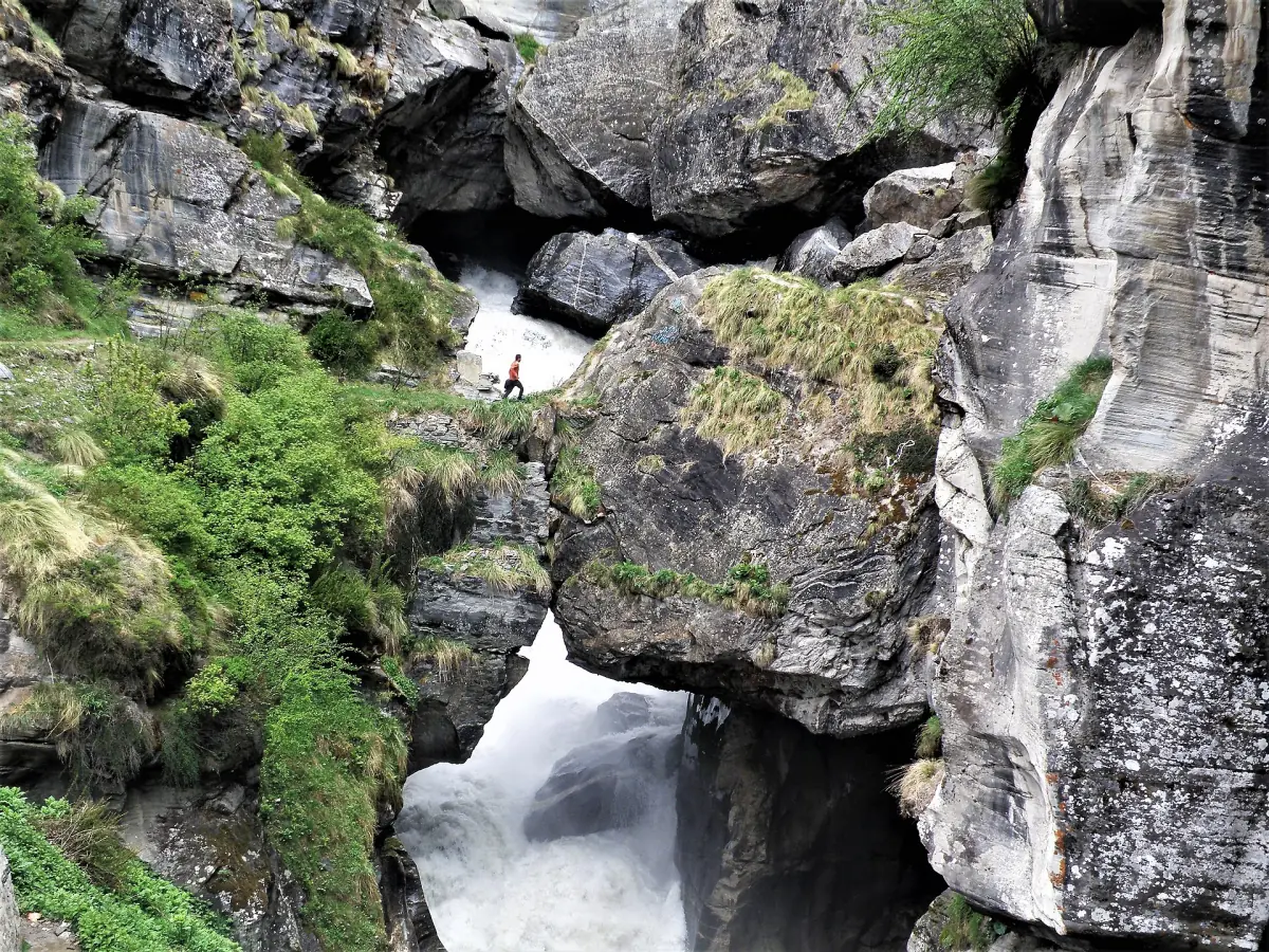 Narrow rocky gorge with water rushing under natural rock slabs