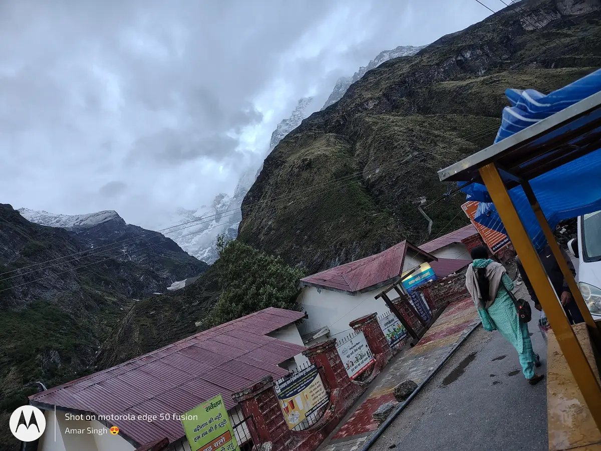 Snow and glacier above tin roofs in a Himalayan settlement